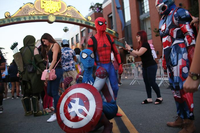 SAN DIEGO, CA - JULY 20: Cosplay characters dressed as Spiderman, pose for pictures along 5th Avenue in the Gaslamp Quarter during Comic Con International in San Diego, California.