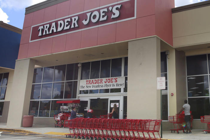 Two types of Trader Joe's cookies with October sell-by dates — Almond Windmill Cookies and Dark Chocolate Chunk and Almond Cookies — have been recalled. Here, people stand in line to enter a Trader Joe's grocery story in Pembroke Pines, Fla., on March 24, 2020.