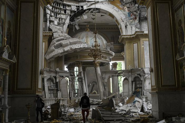 Church personnel inspect the damage inside the Transfiguration Cathedral in Odesa, Ukraine, Sunday, following Russian missile attacks.