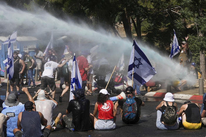 Israeli police use water cannon to disperse demonstrators blocking the road leading to the Knesset, Israel's parliament, during a protest against plans by Prime Minister Benjamin Netanyahu's government to overhaul the judicial system, in Jerusalem, on Monday.