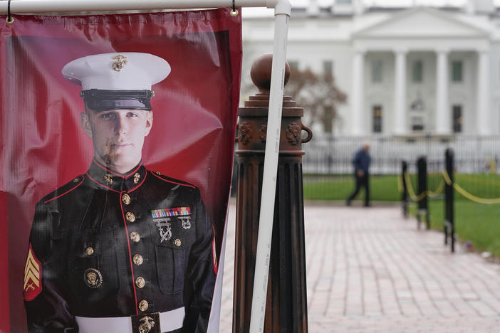 A poster photo of U.S. Marine Corps veteran and former Russian prisoner Trevor Reed stands in Lafayette Park near the White House, March 30, 2022, in Washington. Reed, a former U.S. Marine who was released from Russia in a prisoner swap last year, has been injured while fighting in Ukraine, the State Department said.
