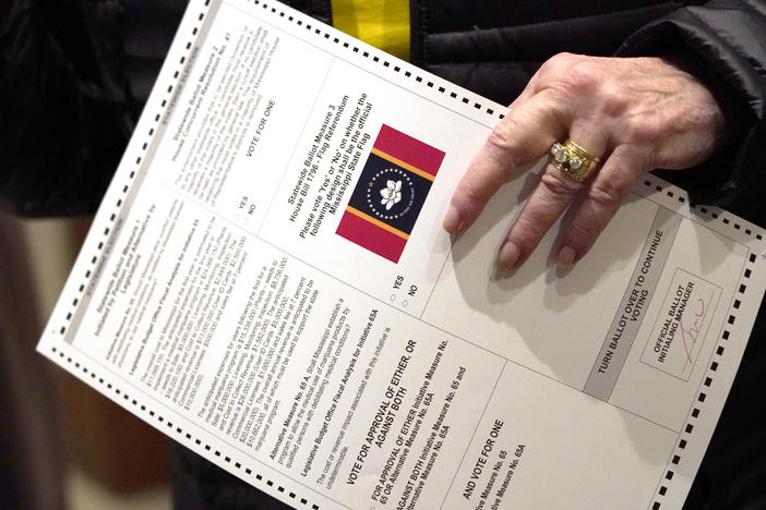 A voter holds a ballot on Election Day in Ridgeland, Miss., on Nov. 3, 2020.