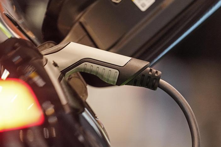 An electric car is charged at the Motor Show in Essen, Germany, Thursday, Dec. 2, 2021. Charging may soon be easier across the U.S. with seven car companies banding together to create a charging network.