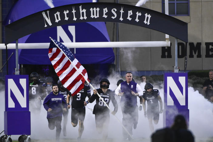 At Northwestern University, allegations of hazing in its football program led to the firing of longtime coach Pat Fitzgerald (right) and has the school facing multiple lawsuits, with more likely. Here, Fitzgerald leads the football team onto the field on Sept. 24, 2022, in Evanston, Illinois.