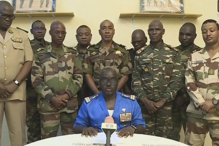 Col. Major Amadou Abdramane, center, is shown speaking during a televised statement. Soldiers claimed on July 26, 2023, to have overthrown the government of Niger President Mohamed Bazoum in a statement read out on national television.