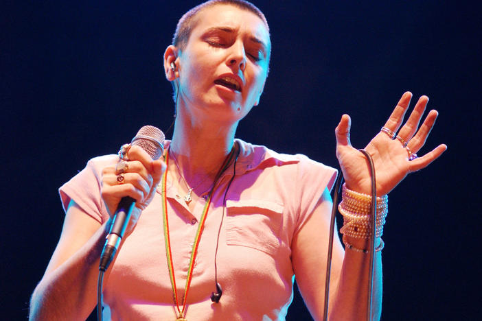 Sinéad O'Connor sings in concert in 2003 at The Point Theatre in Dublin, Ireland. O'Connor has died at 56.