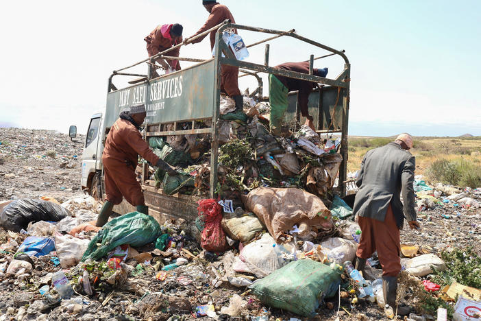 Trash collectors from Marsabit Safi Services offload waste at the Dadach Boshe dump. Even though Kenyan banned single-use plastic bags in 2016, they're still piling up at the dump and blowing off to litter the landscape and bodies of water.