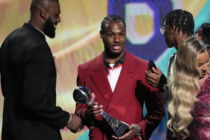 Los Angeles Lakers' LeBron James, left, accepts the award for best record-breaking performance from his sons, Bronny James, center, and Bryce James, at the ESPY awards July 12, 2023, in Los Angeles. Bronny James was hospitalized in stable condition Tuesday, July 25, 2023, a day after going into cardiac arrest while participating in a practice at the University of Southern California.