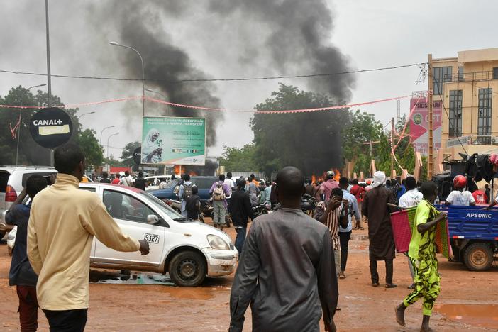 A general view of billowing smoke as supporters of Niger's defense and security forces attack the headquarters of the Nigerien Party for Democracy and Socialism, the party of overthrown President Mohamed Bazoum, in Niamey, Thursday.