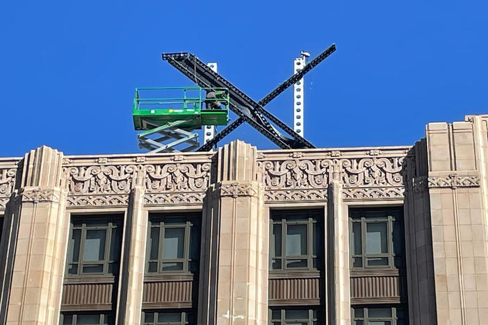 A large metal "X" sign is seen on Friday on top of the downtown San Francisco building that housed what was once Twitter.
