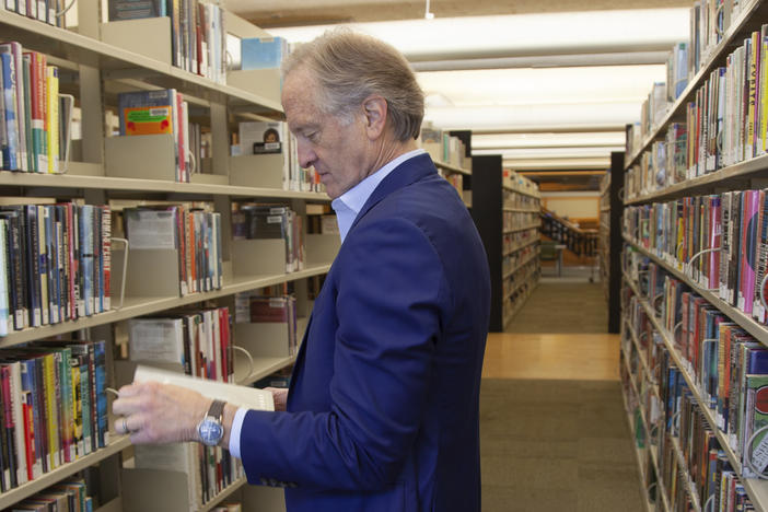 Nate Coulter, executive director of the Central Arkansas Library System (CALS), looks at a book in the main branch of the public library in downtown Little Rock, Ark., on May 23, 2023. Arkansas is temporarily blocked from enforcing a law that would have allowed criminal charges against librarians and booksellers for providing "harmful" materials to minors, a federal judge ruled Saturday, July 29.