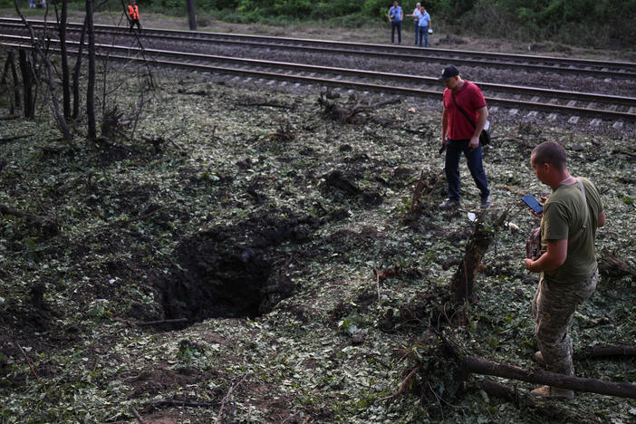 Local residents inspect a crater left after a Russian missile strike  in Zaporizhzhia, July 29.