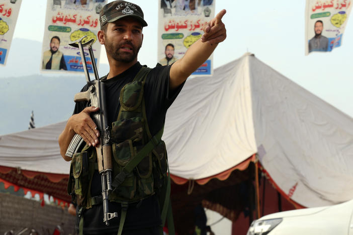 A Pakistani police officer stands guard at the site of Sunday's suicide bomber attack in the Bajur district of Khyber Pakhtunkhwa, Pakistan, on Monday, July 31, 2023.