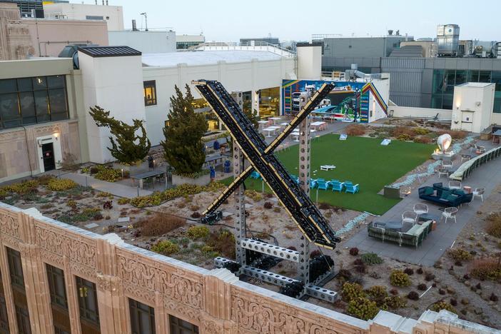 An aerial view shows a newly constructed "X" sign on the roof of the headquarters of the social media platform previously known as Twitter, in San Francisco, on July 29.