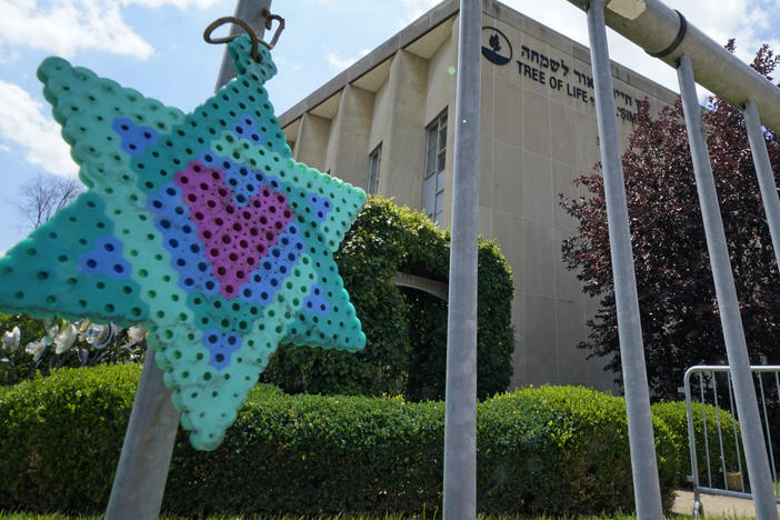 A Star of David hands from a fence outside the dormant landmark Tree of Life synagogue in Pittsburgh in July.