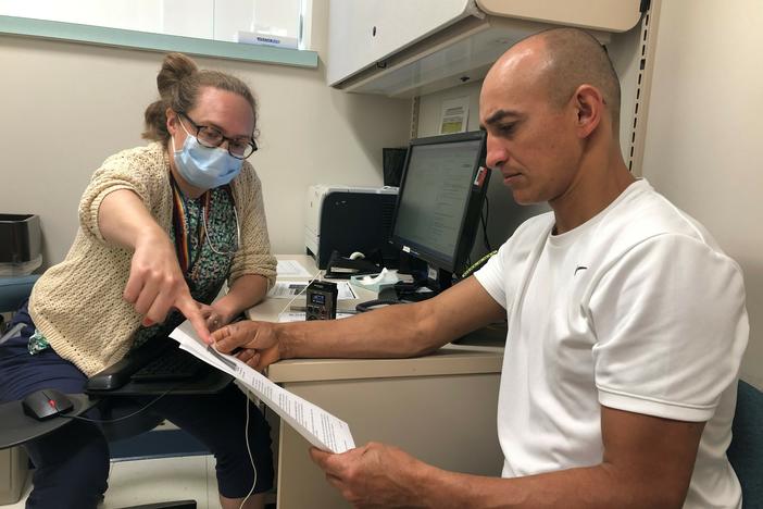 Dr. Rebecca Rogers practices primary care at the Cambridge Health Alliance in Somerville, Mass. During a recent appointment, she went over hydration tips with her patient Luciano Gomes, who works in construction.