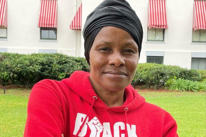 Trish Brown stands in the rain outside Florida's historic Capitol. She's there to raise awareness about social justice issues moving forward in Florida including a proposed constitutional amendment that would protect access to abortion.