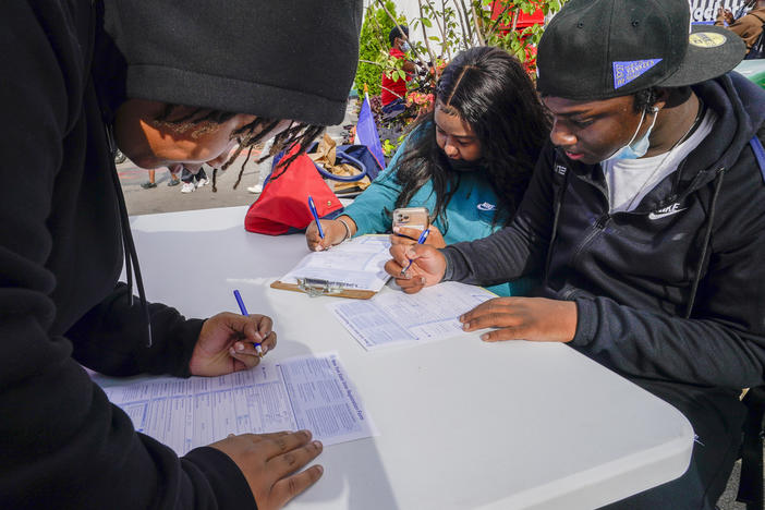 Residents of Brooklyn's Flatbush neighborhood register to vote at a voter registration event on Sept. 29, 2021.