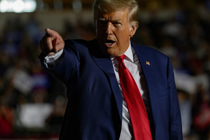 Former President Donald Trump gestures as he enters the Erie Insurance Arena in Erie, Pa., for a political rally while campaigning for the GOP nomination on July 29.