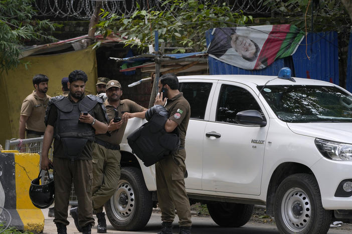 Police officers prepare to take position outside the residence of Pakistan's former Prime Minister Imran Khan, in Lahore, Pakistan, on Saturday, Aug. 5, 2023.
