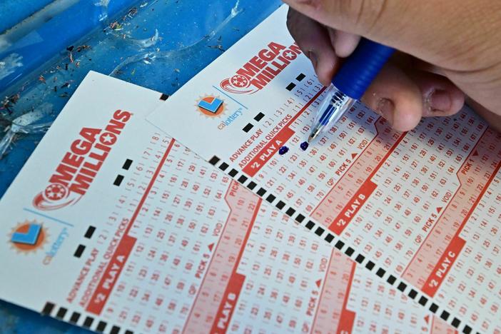 Numbers on tickets for the Mega Millions lottery are selected by a purchaser in Los Angeles on Friday.