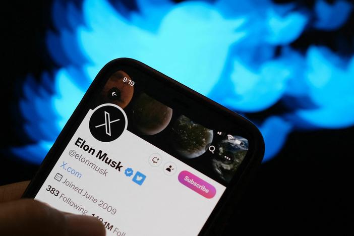 This illustration photo created on July 24 shows the Twitter bird logo in the background of the X account of Elon Musk.