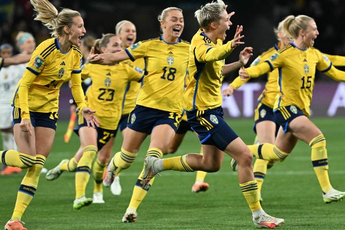 Sweden's forward #08 Lina Hurtig (center) and teammates celebrate their win following a penalty kick shootout over two-time defending champion U.S. at the Women's World Cup. It was the U.S.'s earliest exit from the tournament.