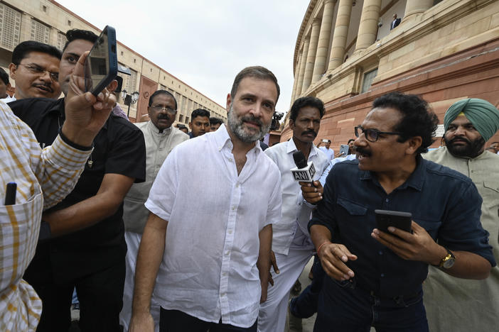 India's top opposition leader Rahul Gandhi, center, arrives at the Parliament in New Delhi, India, Monday. India's Parliament reinstated Gandhi as a lawmaker three days after the country's top court halted his criminal defamation conviction for mocking Prime Minister Narendra Modi's surname.