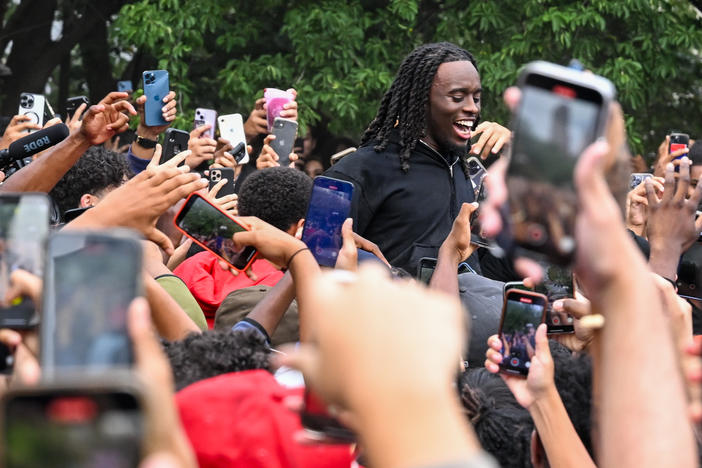 People gather around and cheer for Kai Cenat during the meetup that eventually resulted in dozens of arrests and several injuries.