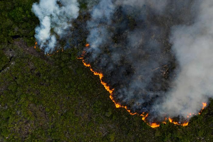 Aerial view showing a fire at the Chapada Diamantina region, between the cities of Andarai and Mucuge, in Bahia state, northeastern Brazil, on October 7, 2020. - Chapada Diamantina National Park preserves areas of three Brazilian biomes: Mata Atlantica, Cerrado and Caatinga among its 152,000 hectares.