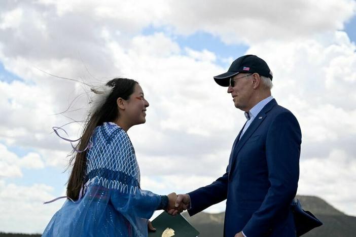 Maya Tilousi, member of the Hopi Tribe, Havasupai Tribe of Grand Canyon, and the Cheyanne and Arapaho Tribes, shakes hands with President Biden after introducing him at Red Butte Airfield, 25 miles south of Tusayan, Ariz., on Tuesday.