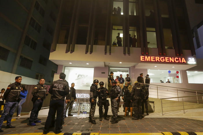 Police guard the hospital where several of the injured were taken after an attack against presidential candidate Fernando Villavicencio in Quito, Ecuador, on Wednesday.