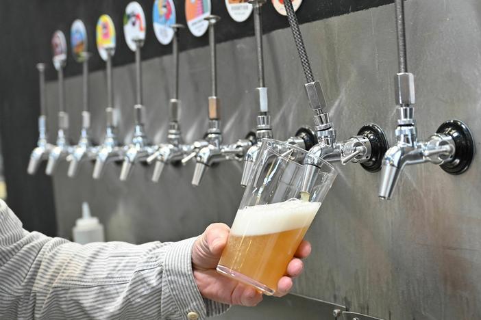 A pint of beer is poured at Pressure Drop Brewery, in north London, in 2022.