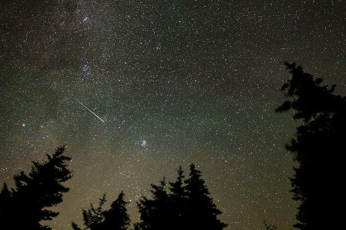 In this 30 second exposure, a meteor streaks across the sky during the annual Perseid meteor shower, Wednesday, Aug. 11, 2021, in Spruce Knob, West Virginia.