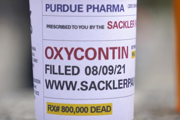 Fake pill bottles with messages about OxyContin maker Purdue Pharma were displayed during a protest outside the courthouse where the bankruptcy of the company was taking place in White Plains, N.Y. in 2021.