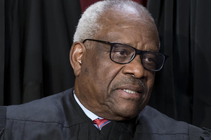 Associate Justice Clarence Thomas joins other members of the Supreme Court as they pose for a group portrait on Oct. 7, 2022.