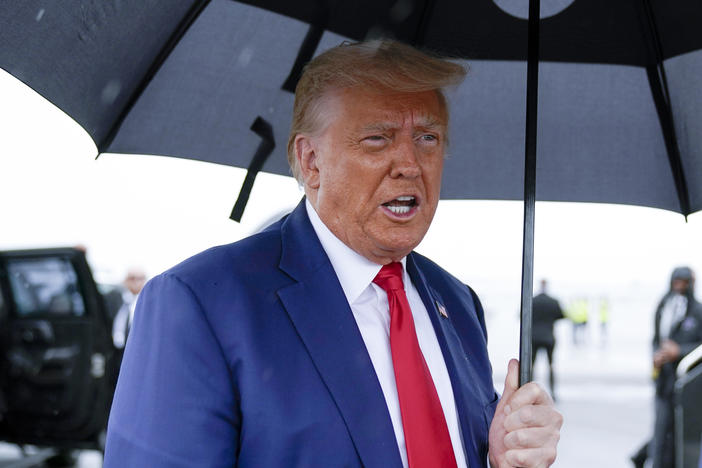 Former President Donald Trump speaks before he boards his plane at Ronald Reagan Washington National Airport on August 3 in Arlington, Va.