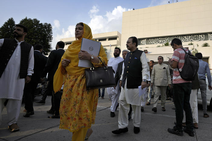 Lawmakers of the National Assembly arrive for a group photo with Pakistan's Prime Minister Shehbaz Sharif at the end of the last session of the current parliament, in Islamabad, Pakistan, Wednesday, Aug. 9, 2023.