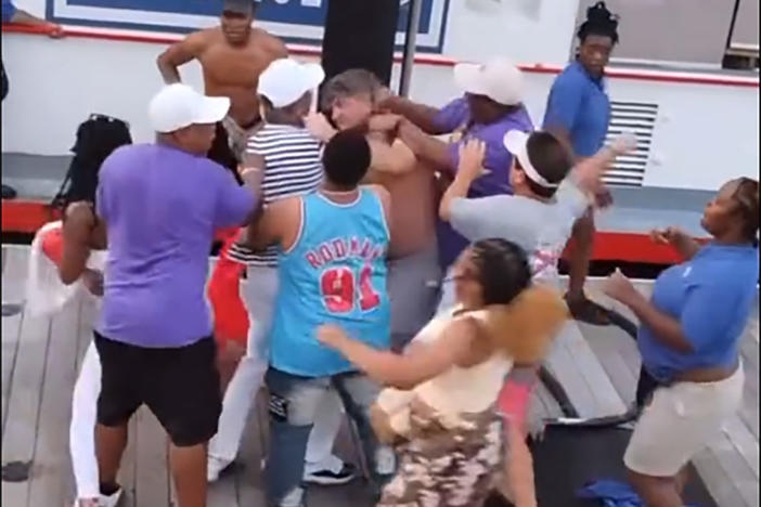 A screenshot from one of the videos of the brawl in Montgomery, Ala., on Saturday. The video shows a fight that broke out between an apparent dock worker and several men who appeared to be parking their pontoon boat in a space reserved for the city's riverboat.