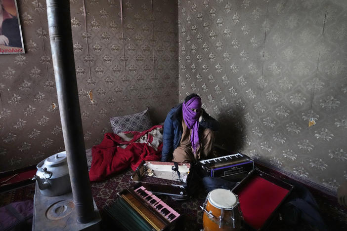 In 2022, a man in Kabul covered his face to protect his identity, as he showed his harmonium musical instrument. The Taliban have begun to burn these instruments, and others.