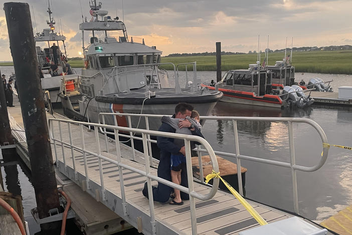 The U.S. Coast Guard and U.S. Navy brought four divers back to their families after a search aircraft spotted an SOS strobe.