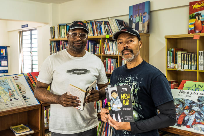 Kwame Alexander (left) and Jerry Craft have each won a Newbery Medal for their children's books. Alexander invited Craft on a trip to Kenya this summer to speak to schoolkids about reading. The kids were impressed. So were the authors.