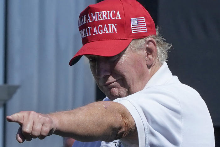 Former President Donald Trump points at a crowd at a golf tournament at Trump National in Bedminster, N.J., on Sunday.