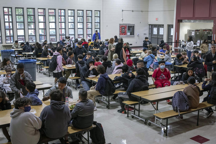 Students eat lunch in the cafeteria at Tonalea K-8 school in Scottsdale, Ariz., on Dec. 12, 2022. In Massachusetts, a new 4% state income tax on incomes above $1 million will help pay for free school lunches.