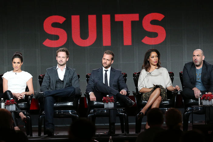 (From left) executive producer Aaron Korsh sits with actors Meghan Markle, Patrick J. Adams, Gabriel Macht, Gina Torres, Rick Hoffman and Sarah Rafferty of the TV show <em>Suits</em> in 2014.