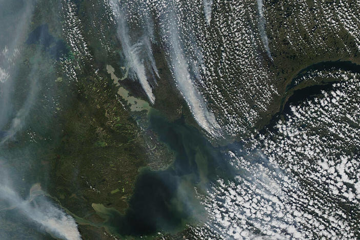 Wildfires outside of Yellowknife, the capital of Canada's Northwest Territories, as seen from space on Tuesday. As of Thursday the fires are less than 10 miles outside of the city.