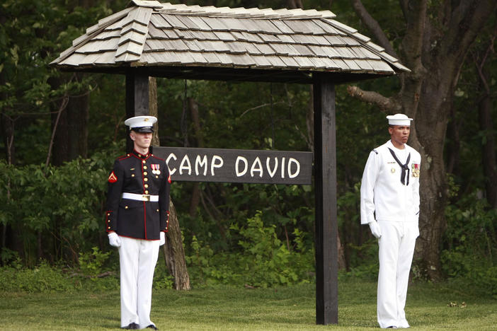 Members of an honor guard stand at attention for the arrival of the Crown Prince of Abu Dhabi to Camp David on June 26, 2008.