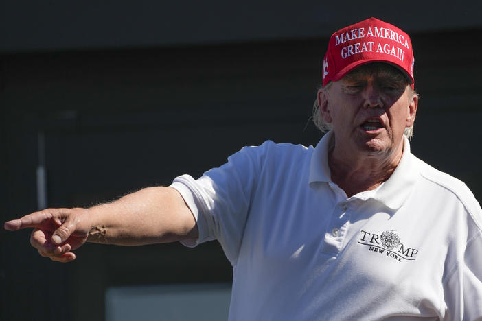 Former President Donald Trump talks to people in the crowd during the final round of the Bedminster Invitational LIV Golf tournament in Bedminster, N.J., Sunday, Aug. 13, 2023.