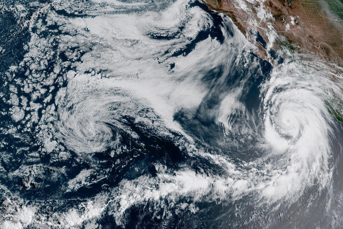 This 1:10 p.m. EDT Friday satellite image provided by the National Oceanic and Atmospheric Administration shows Hurricane Hilary (right) off Mexico's Pacific coast.