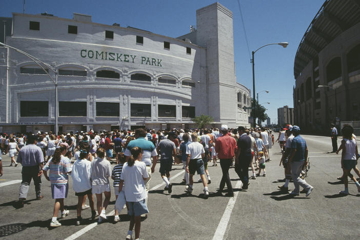 Fans and spectators walk to the entrance of Chicago's Comiskey Park on April 9, 1990, for the opening day of the final Major League Baseball season there.